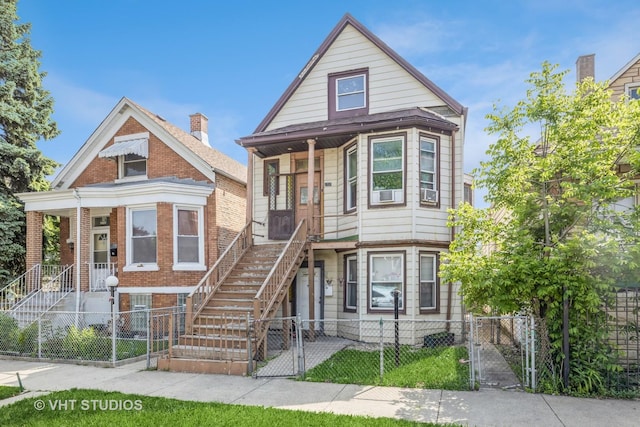 2737 S Karlov Ave, Chicago, IL 60623 - victorian house with stairway, a gate, a porch, and a fenced front yard