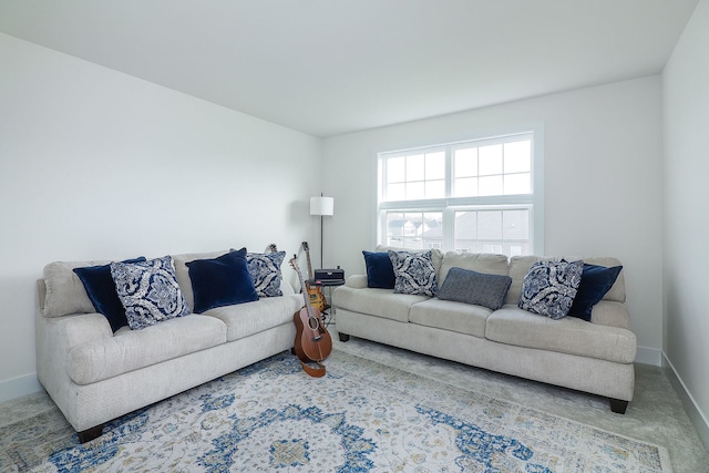 carpeted living room featuring baseboards