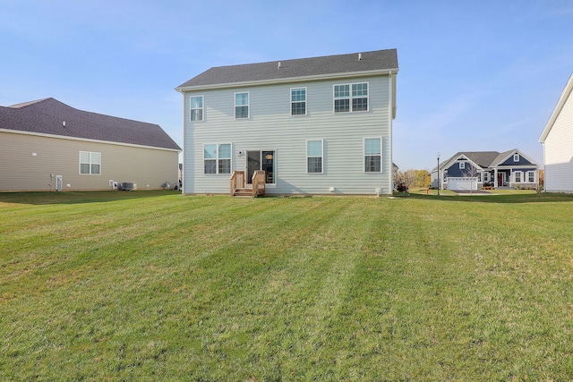 rear view of house featuring central AC and a yard