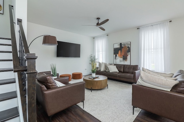 living room featuring stairs, a ceiling fan, and wood finished floors