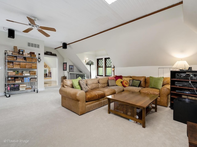 carpeted living room with ceiling fan, visible vents, and vaulted ceiling