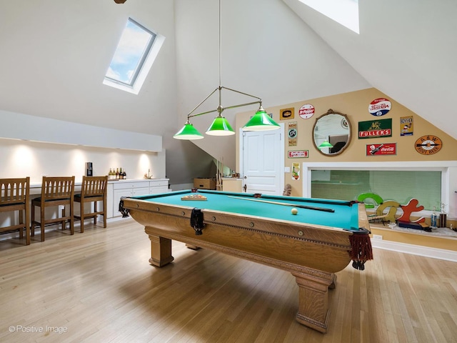 game room with high vaulted ceiling, light wood finished floors, a skylight, and billiards