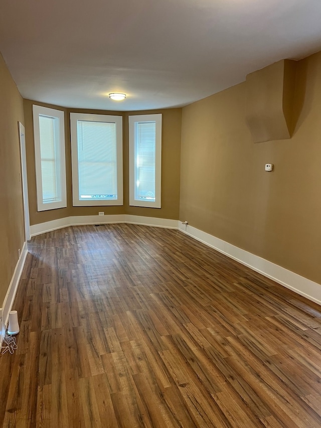 spare room with dark wood-type flooring