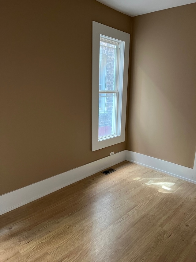 spare room featuring light hardwood / wood-style floors