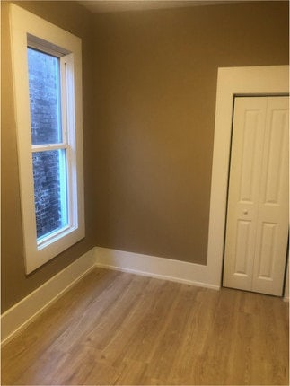 empty room with hardwood / wood-style floors