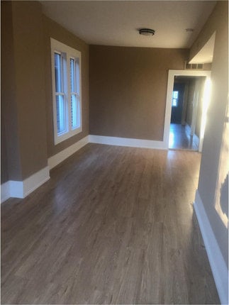 empty room with dark hardwood / wood-style floors