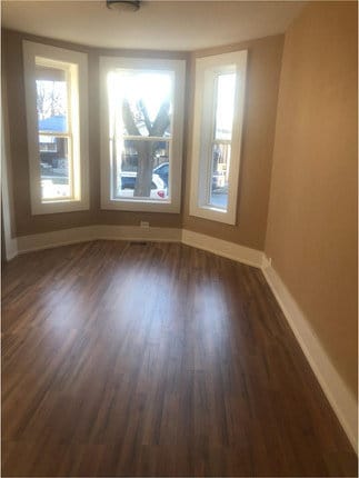 spare room featuring dark hardwood / wood-style floors