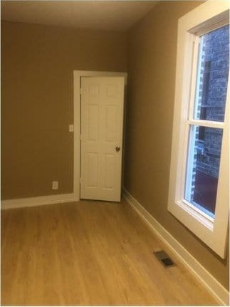 unfurnished room with hardwood / wood-style floors