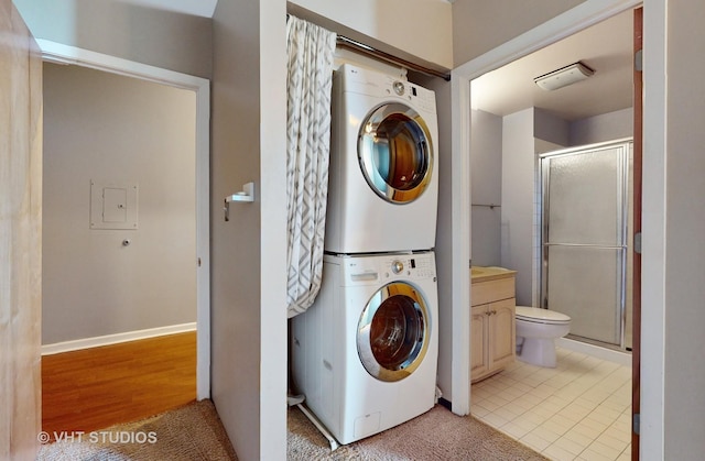 laundry room with stacked washer / dryer and laundry area