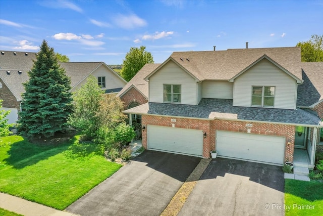 view of front of property with a front yard and a garage