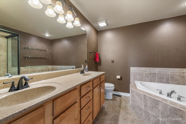 bathroom featuring toilet, vanity with extensive cabinet space, double sink, tiled bath, and tile floors