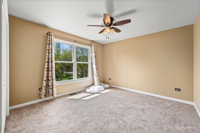 carpeted spare room with ceiling fan