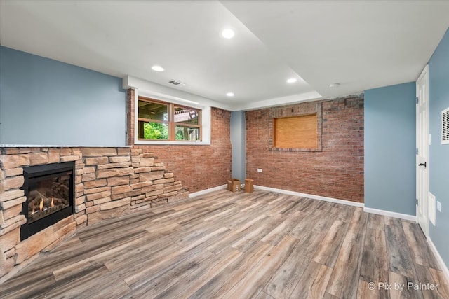 unfurnished living room with a fireplace and hardwood / wood-style flooring