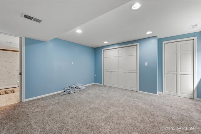 unfurnished bedroom featuring connected bathroom and carpet