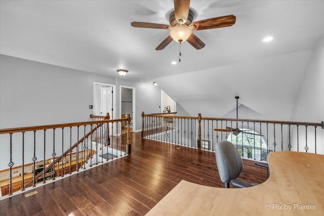 corridor featuring dark hardwood / wood-style floors and vaulted ceiling