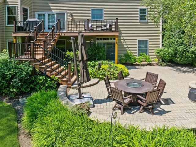 rear view of property with stairs, a patio, and a wooden deck
