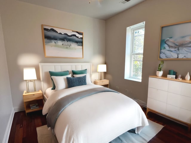 bedroom with dark hardwood / wood-style flooring