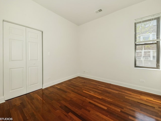 spare room with dark hardwood / wood-style floors