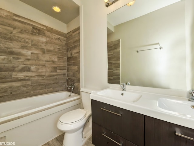 full bathroom with vanity, toilet, and tiled shower / bath