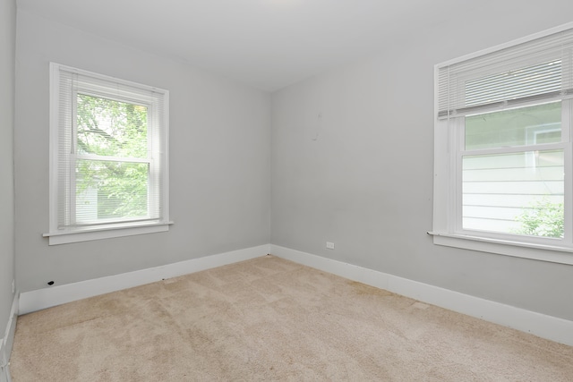 unfurnished room with light colored carpet