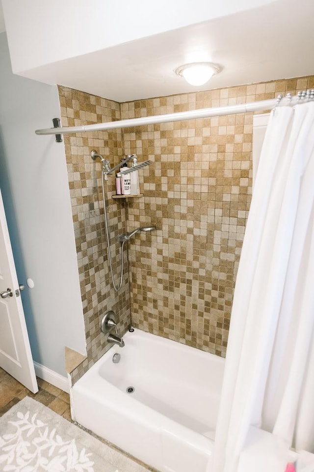 bathroom with tile patterned flooring and shower / bath combination with curtain