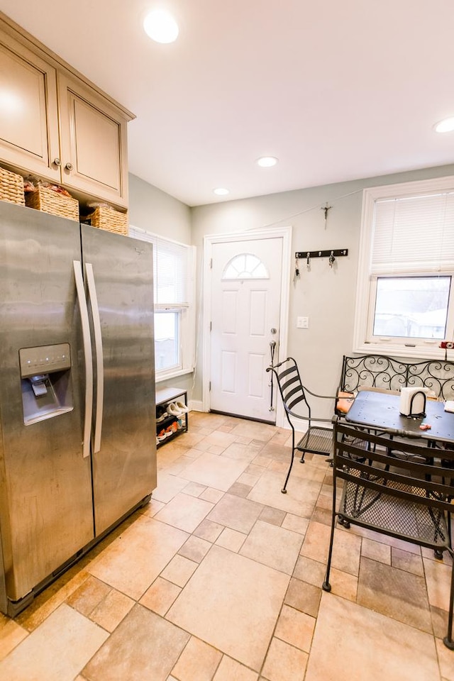 kitchen featuring stainless steel fridge with ice dispenser and cream cabinets