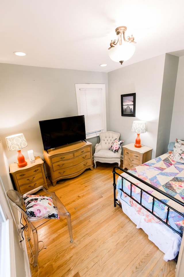 bedroom with hardwood / wood-style flooring