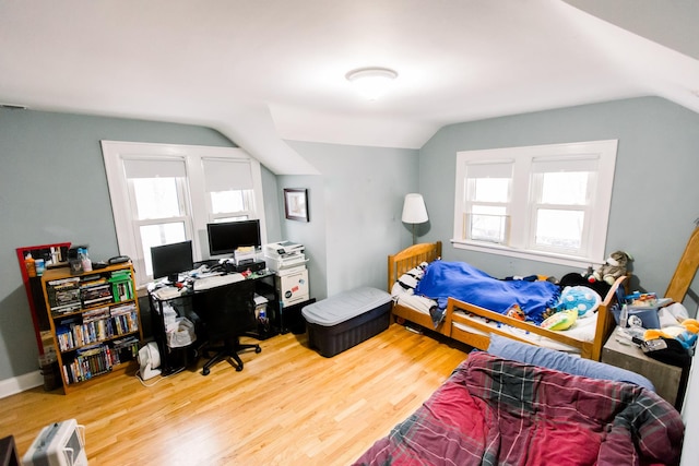 bedroom featuring wood-type flooring and vaulted ceiling