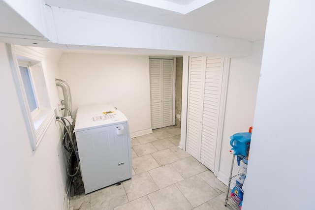 laundry room featuring washer / dryer and light tile patterned floors