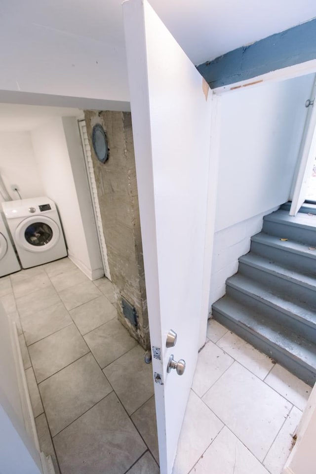 staircase featuring washing machine and clothes dryer