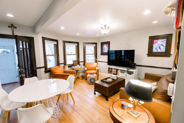 living room featuring hardwood / wood-style flooring and beamed ceiling