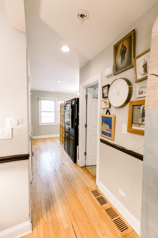 hall with light hardwood / wood-style flooring