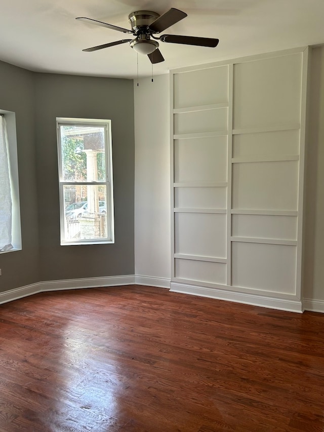 spare room featuring dark hardwood / wood-style floors and ceiling fan