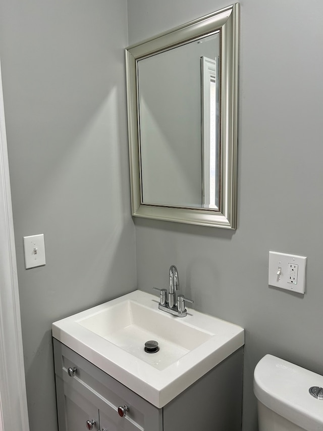 bathroom featuring toilet and large vanity