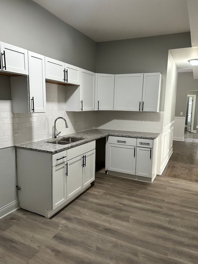 kitchen featuring white cabinets, sink, dark hardwood / wood-style flooring, and tasteful backsplash