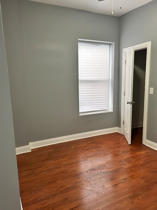 spare room featuring hardwood / wood-style flooring, a healthy amount of sunlight, and ceiling fan