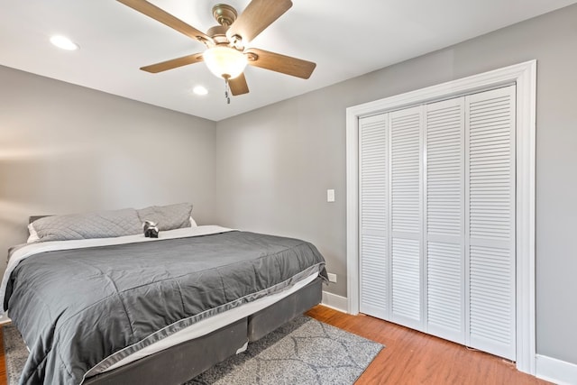 bedroom with a closet, ceiling fan, and hardwood / wood-style flooring