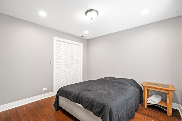 bedroom with a closet and hardwood / wood-style flooring