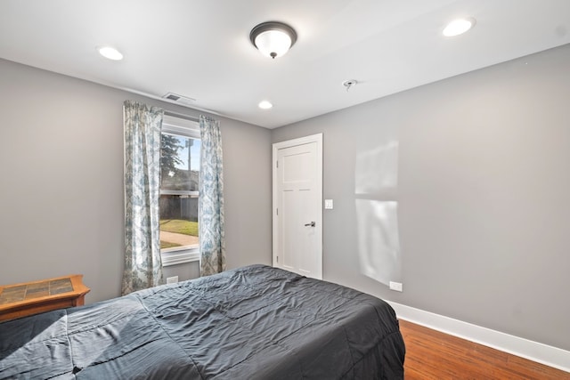 bedroom with hardwood / wood-style floors