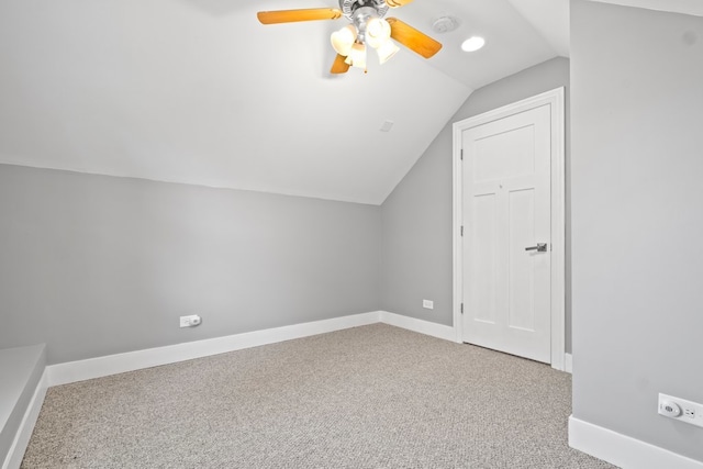 additional living space with vaulted ceiling, carpet flooring, and ceiling fan