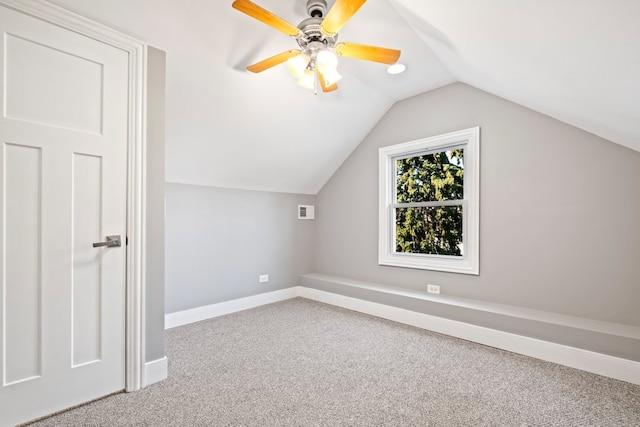 additional living space featuring vaulted ceiling, carpet flooring, and ceiling fan