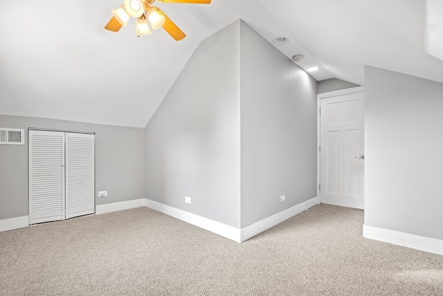 bonus room featuring lofted ceiling, carpet flooring, and ceiling fan