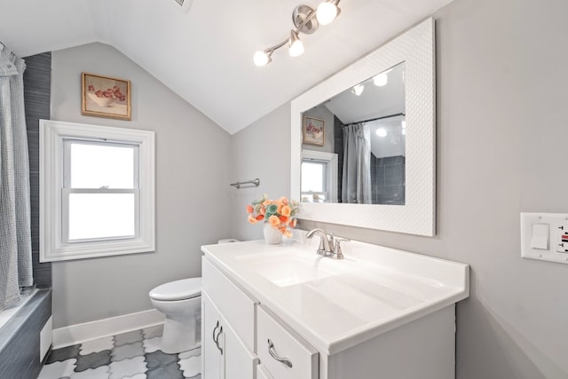 bathroom with toilet, lofted ceiling, and vanity