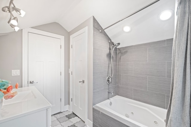 bathroom featuring vanity, lofted ceiling, and shower / bath combination with curtain