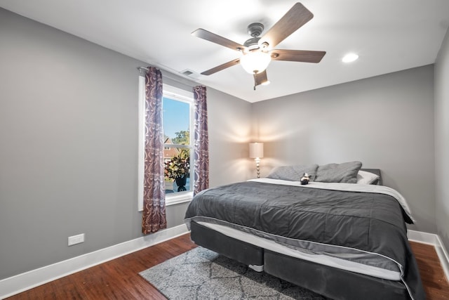 bedroom featuring dark hardwood / wood-style floors and ceiling fan