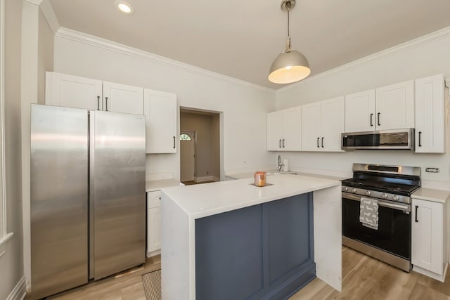 kitchen with appliances with stainless steel finishes, hanging light fixtures, white cabinetry, and light wood-type flooring