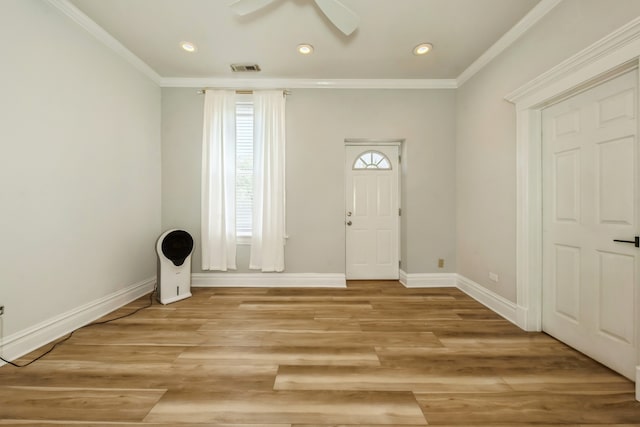 foyer with ceiling fan, crown molding, light wood-type flooring, and a wealth of natural light