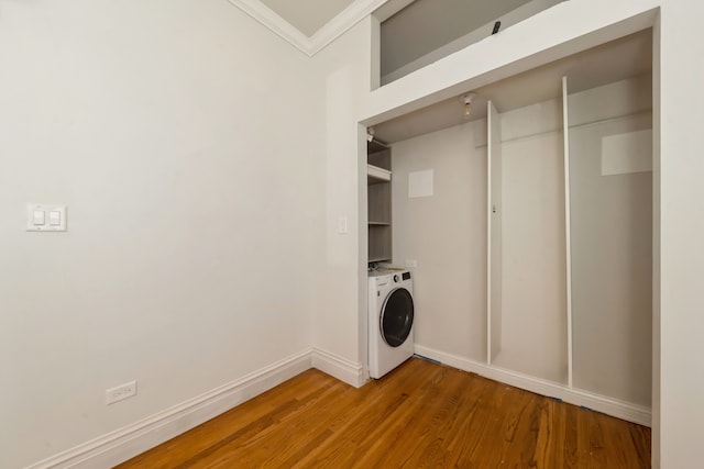 laundry room featuring ornamental molding, separate washer and dryer, and hardwood / wood-style floors