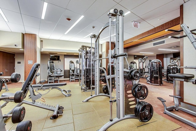 gym with a paneled ceiling