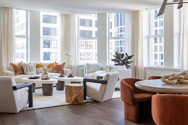 living room with hardwood / wood-style flooring, crown molding, and built in features